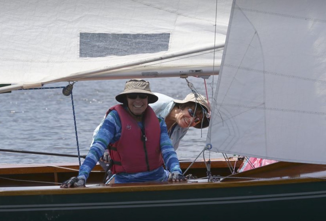 An experienced female sailor by their side