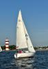 CALYPSO under sail, crossing the starting line during a Lake Conroe Sailing Association Summer Series race. 