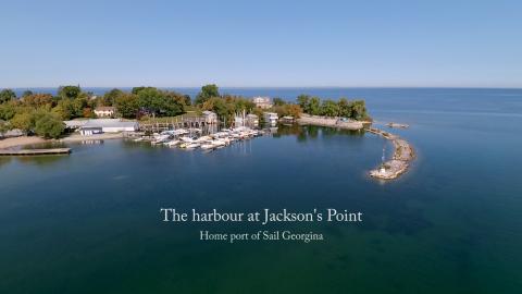 A aerial photograph of Jackson's Point Harbour looking over the breakwater and slips from the east.