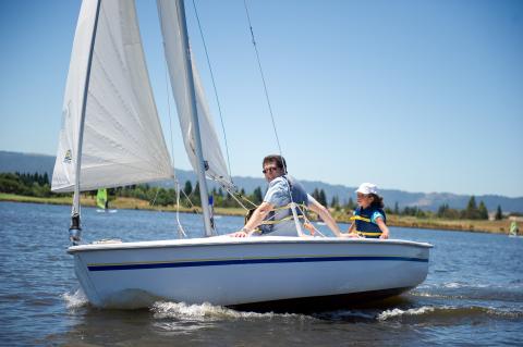 Shoreline Lake Summer Sailstice Celebration (young girl skippering sailboat ride on Capri dinghy)
