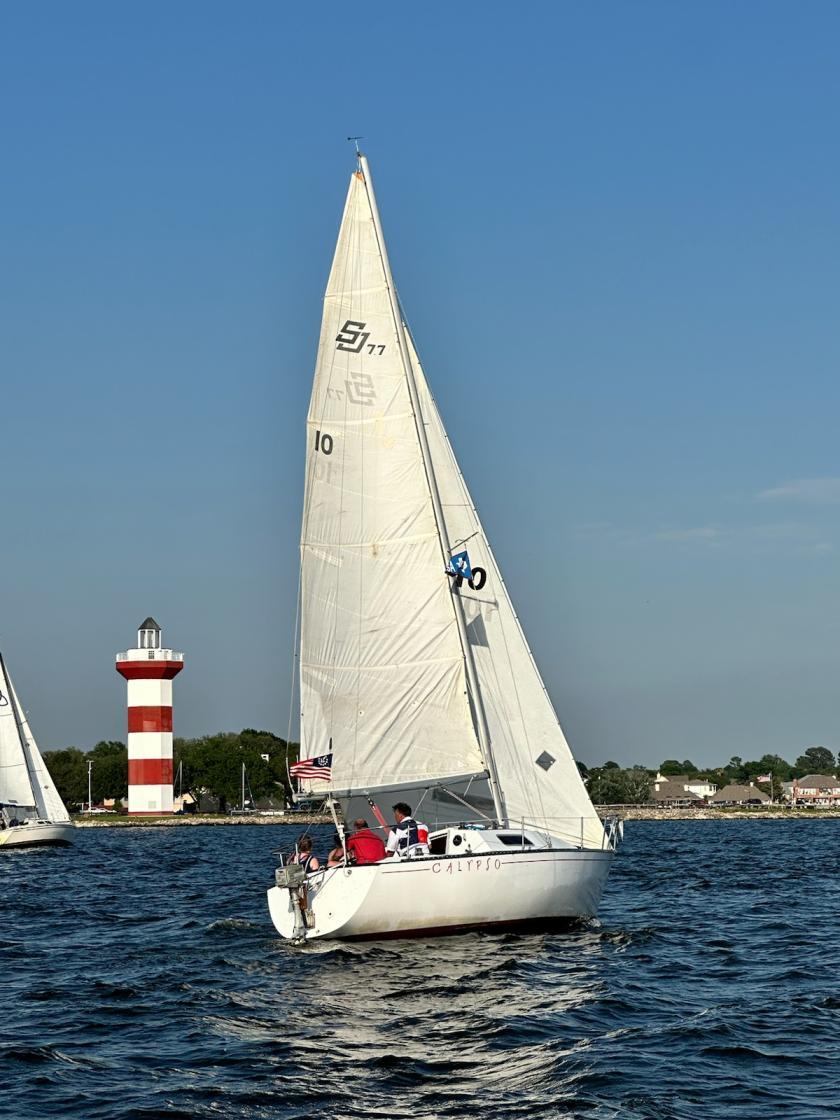 CALYPSO under sail, crossing the starting line during a Lake Conroe Sailing Association Summer Series race. 